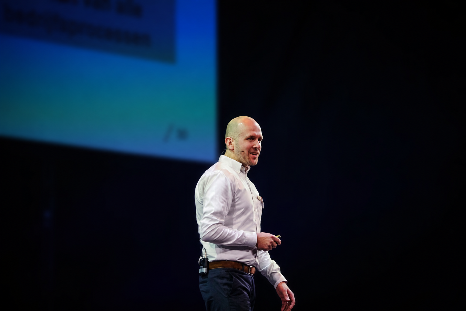 Carlo speaking on stage.